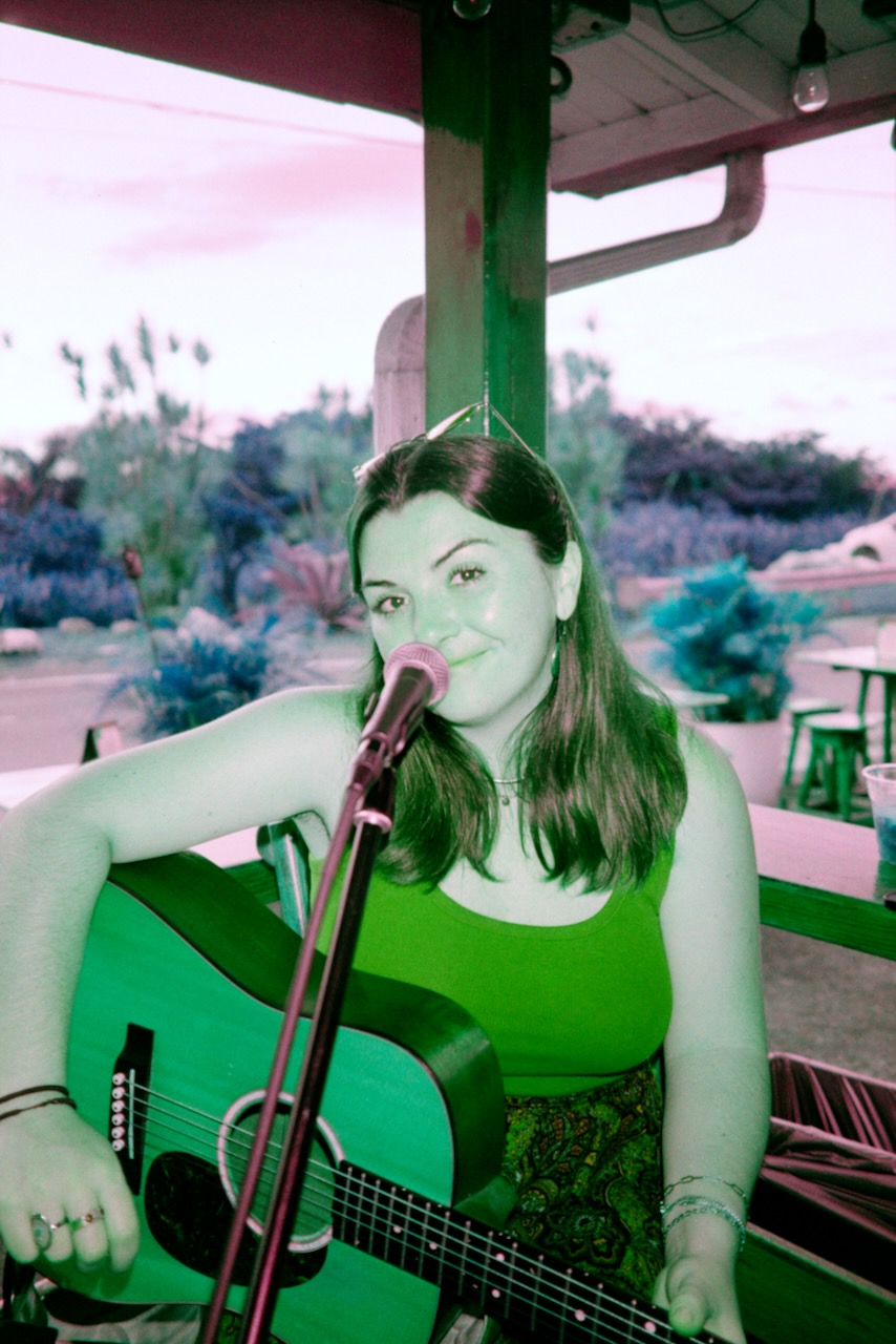 Samantha performing with guitar